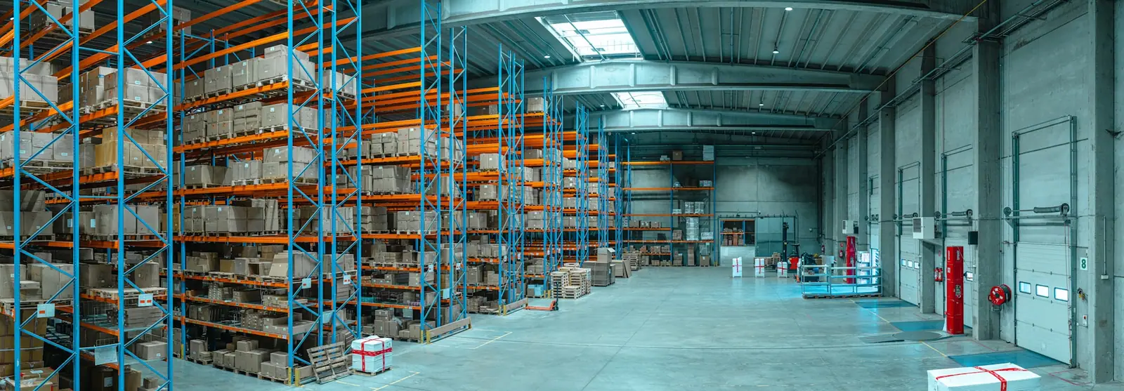 High commercial shelving in a neutral storage space, illustrating organised product flow.