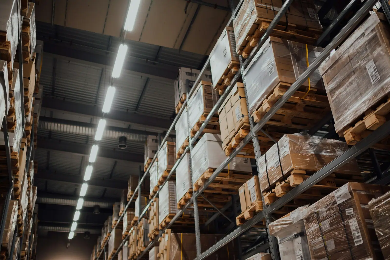 Organised cartons on warehouse shelving, representing structured wholesale supply.