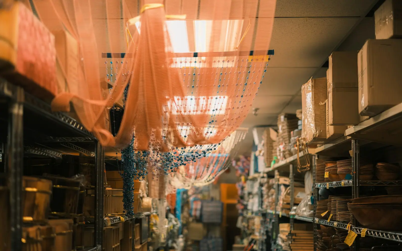 A tidy retail stockroom with stocked shelving, representing retail and reseller supply.